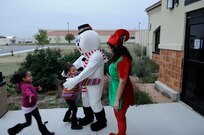 Frosty the Snowman and Elf Denise Mena greet children outside the base exchange food court at JBSA-Randolph during the Breakfast with Santa event Dec. 10. (U.S. Air Force photo/Don Lindsay)