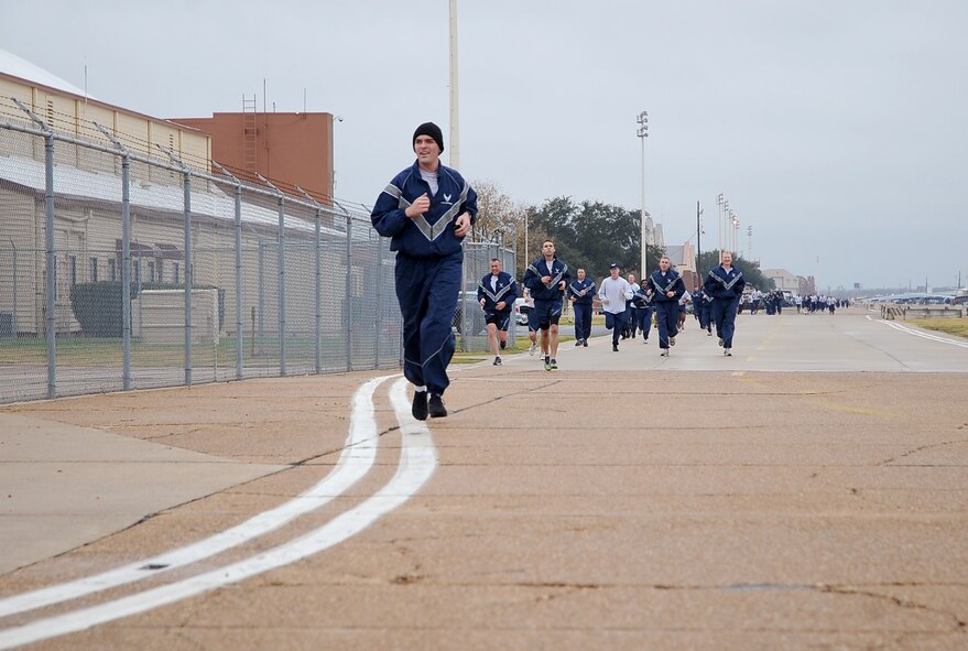 Barksdale Airmen run toward the finish line Dec. 16 during the Ham Haul Fun Run at the flightline on Barksdale Air Force Base, La. More than 80 Airmen participated in the event, only the second time in several years a fun run was held on the base flightline. (U.S. Air Force photo/Senior Airman Amber Ashcraft)(RELEASED)