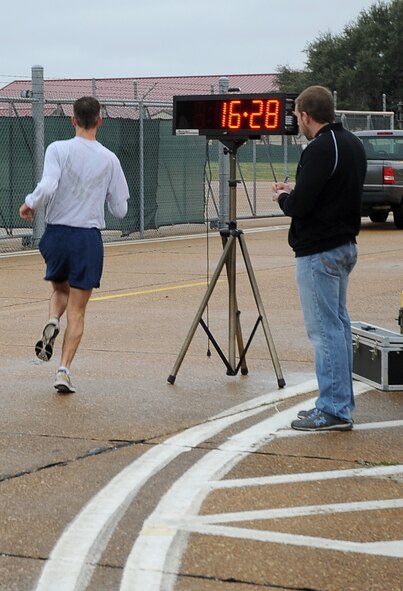 An Airmen finishes the Ham Haul Fun Run Dec. 16 at the flightline on Barksdale Air Force Base, La. More than 80 Airmen attended the approximate three-mile run. Prizes, raffled off after the completion of the run, included 30 hams, a digital camera set, portable DVD kit and several workout kits. (U.S. Air Force photo/Senior Airman Amber Ashcraft)(RELEASED)