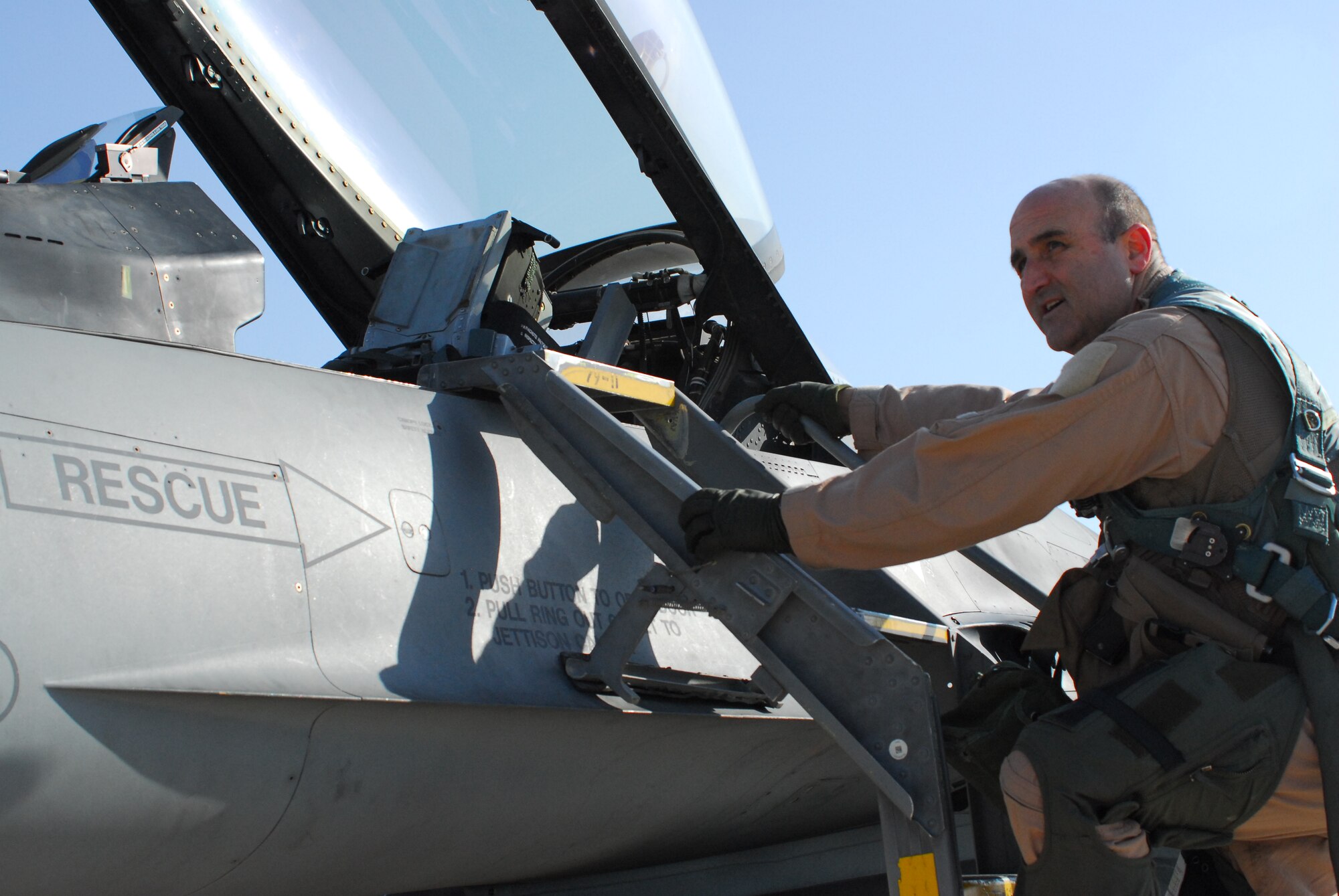 Col. Rodney Petithomme, 332nd Expeditionary Operations Group commander, climbs down the ladder of a F-16 Fighting Falcon after flying one of the last two combat aircraft over Iraq Dec. 18, 2011. He helped provide top cover for the last convoys leaving the country. Petithomme is a native of Angels Camp, Calif., and is deployed from Osan Air Base, Republic of Korea. (U.S. Air Force/1st Lt. Rusty Ridley)
