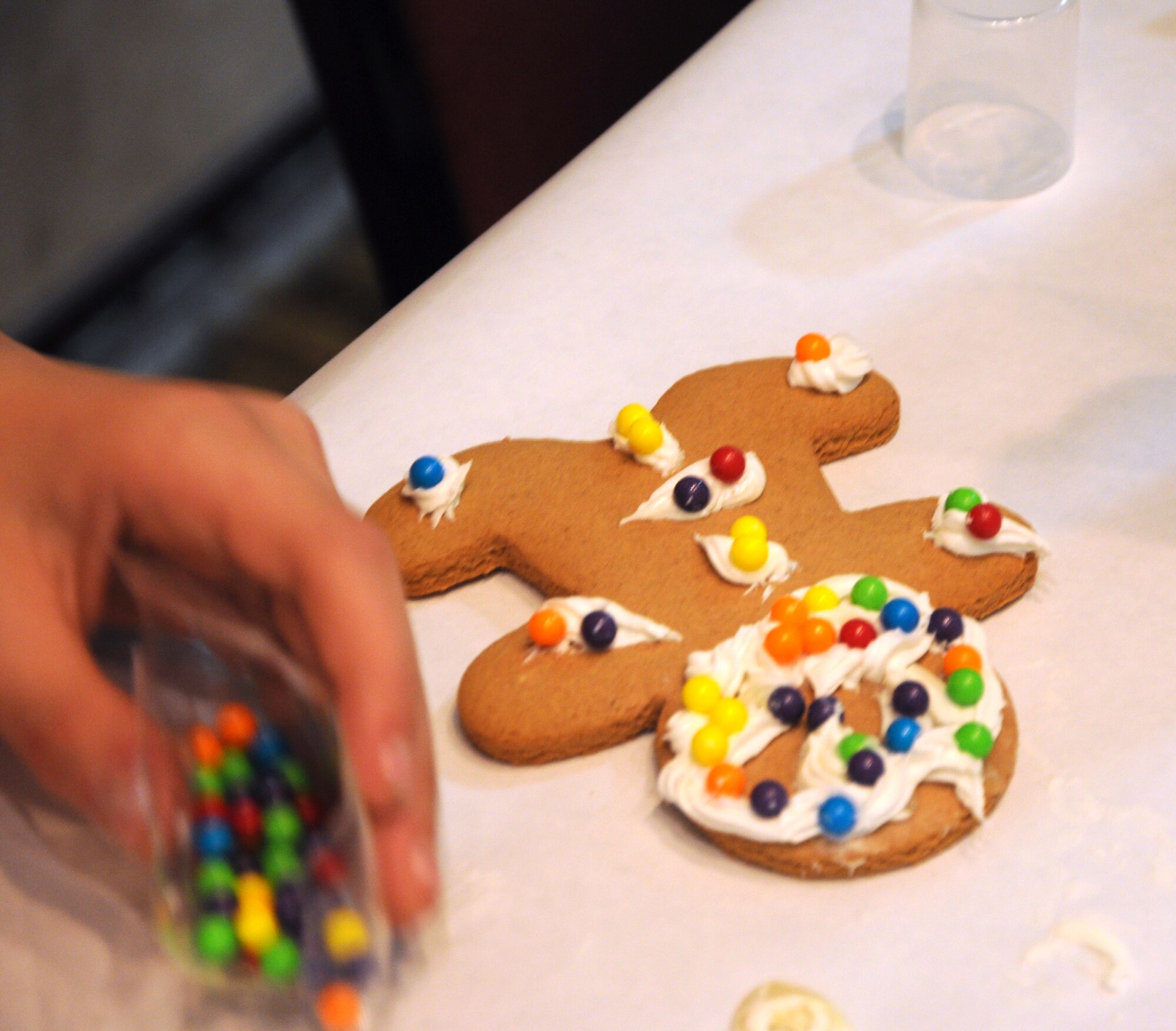 GOODFELLOW AIR FORCE BASE, Texas—The holiday breakfast, at the Event Center Dec. 17, offered several children’s events, including making gingerbread men, coloring activities, singing and food before Santa Clause arrived to pass out more than 300 gifts to the children. The event was organized by the Airman and Family Readiness Center to support families of deployed members and members of the Exceptional Family Member Program, families with a special needs child. (U.S. Air Force photo/Airman 1st Class Jessica Keith) 