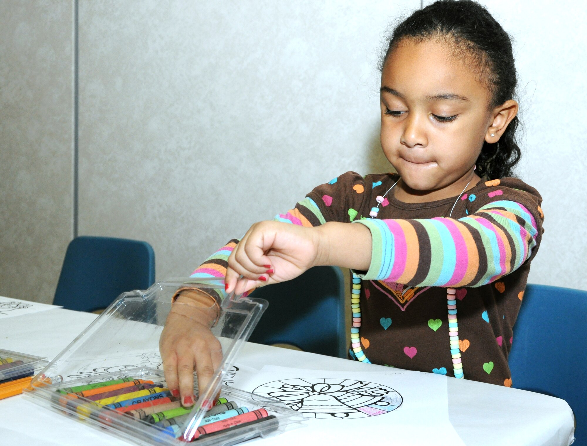 GOODFELLOW AIR FORCE BASE, Texas—Natasha Taylor, 4, daughter of Master Sgt. Rachel Taylor, 17th Force Support Squadron  1st Sgt. works on a coloring page during a holiday breakfast at the Event Center, here, Dec. 17. First Sergeants came to support the event, organized by the AFRC to support families of deployed members and members of the Exceptional Family Member program, families with a child who has special needs. (U.S. Air Force photo/Airman 1st Class Jessica Keith)