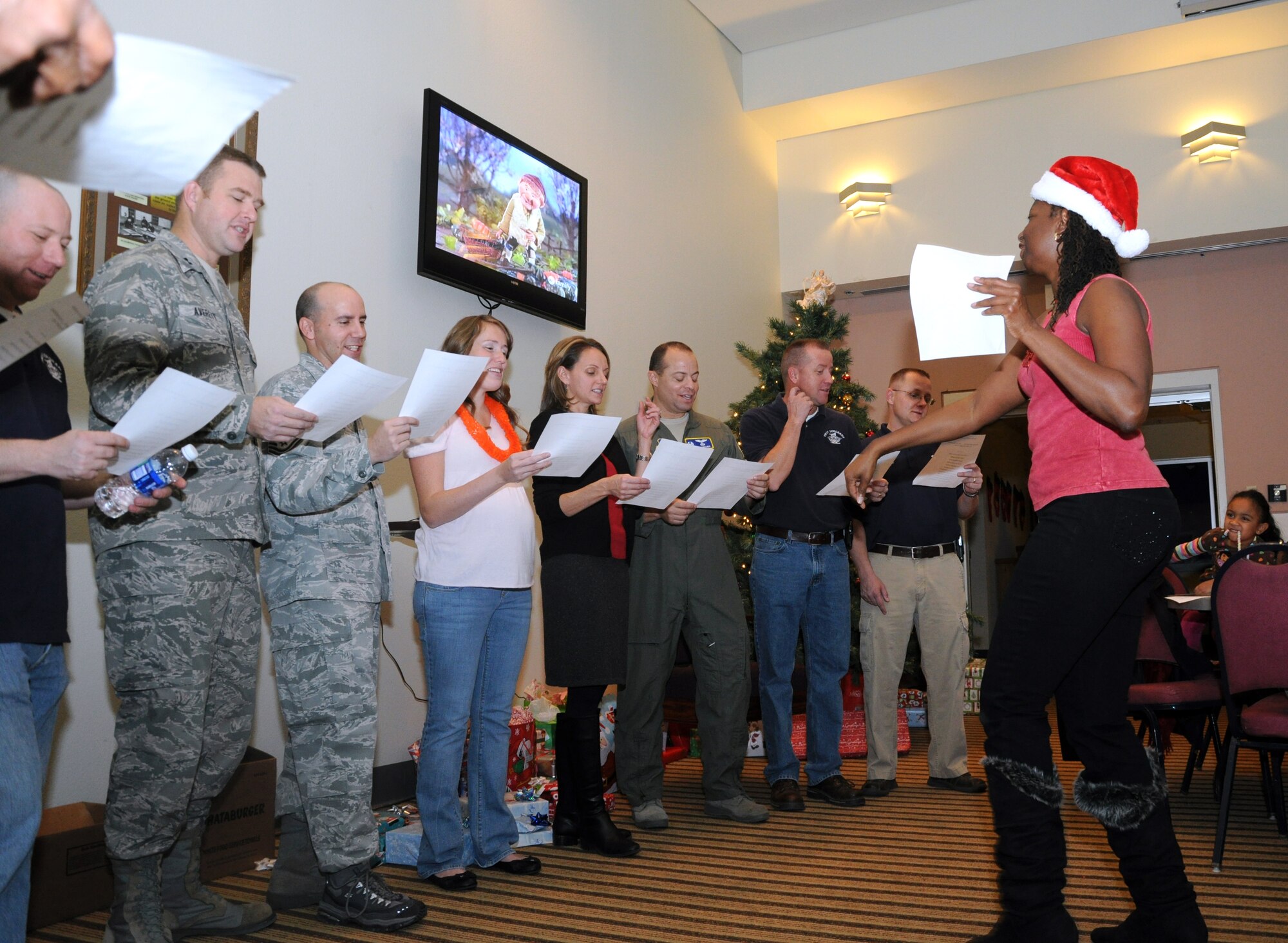 GOODFELLOW AIR FORCE BASE, Texas-- Pamela Flemions, 17th Training Wing Airman and Family Readiness Center work life consultant, leads wing leadership, first sergeants and key spouses in a rendition of The Twelve Days of Christmas, during a holiday breakfast at the Event Center Dec. 17.  The event was organized by the AFRC for families of deployed members or members of the Exceptional Family Member program, families with a child who has special needs. (U.S. Air Force photo/Airman 1st Class Jessica Keith)
