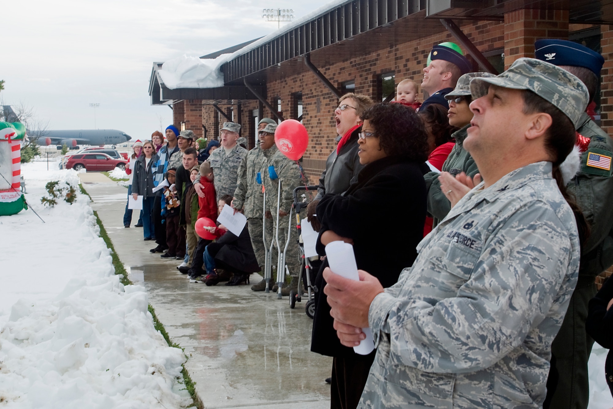 GRISSOM AIR RESERVE BASE, Ind. -- Airmen of the 434th Air Refueling Wing and their families react to the lighting of a large, white pine Christmas tree outside the Airman and Family Readiness building here Dec. 3. The tree was lit to usher in the holiday season here at Grissom. (U.S. Air Force photo/Senior Airman Andrew McLaughlin)
