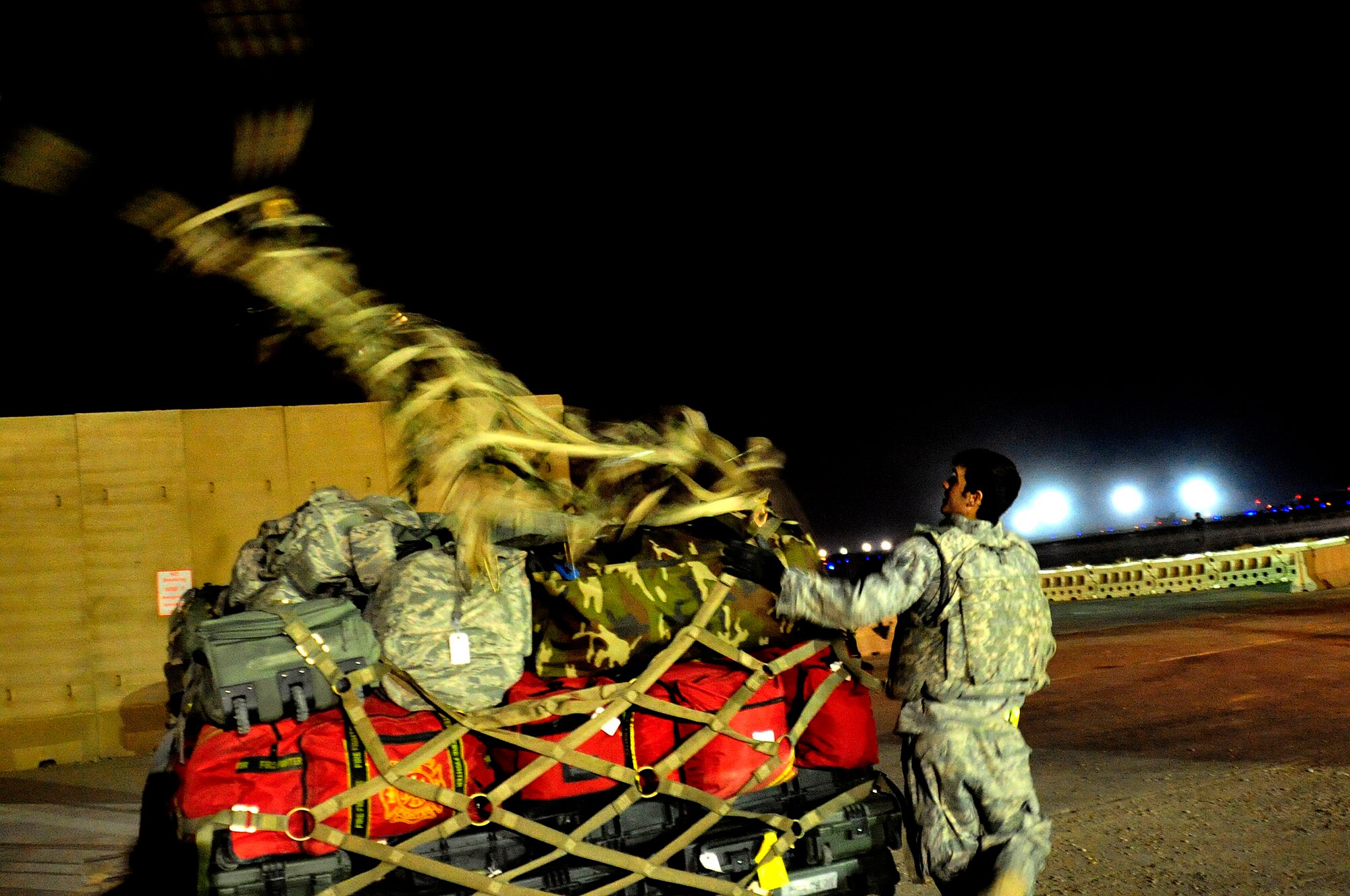 An 407th Air Expeditionary Wing aerial porter prepares the last pallet to be transported out of Ali Air Base, Iraq, Dec. 18, 2011. A group of Airmen were the last service members to redeploy from Iraq based on the Iraq and U.S. 2008 Security Agreement that required all U.S. service members to be out of the country by Dec. 31. (U.S. Air Force photo/Master Sgt. Cecilio Ricardo)