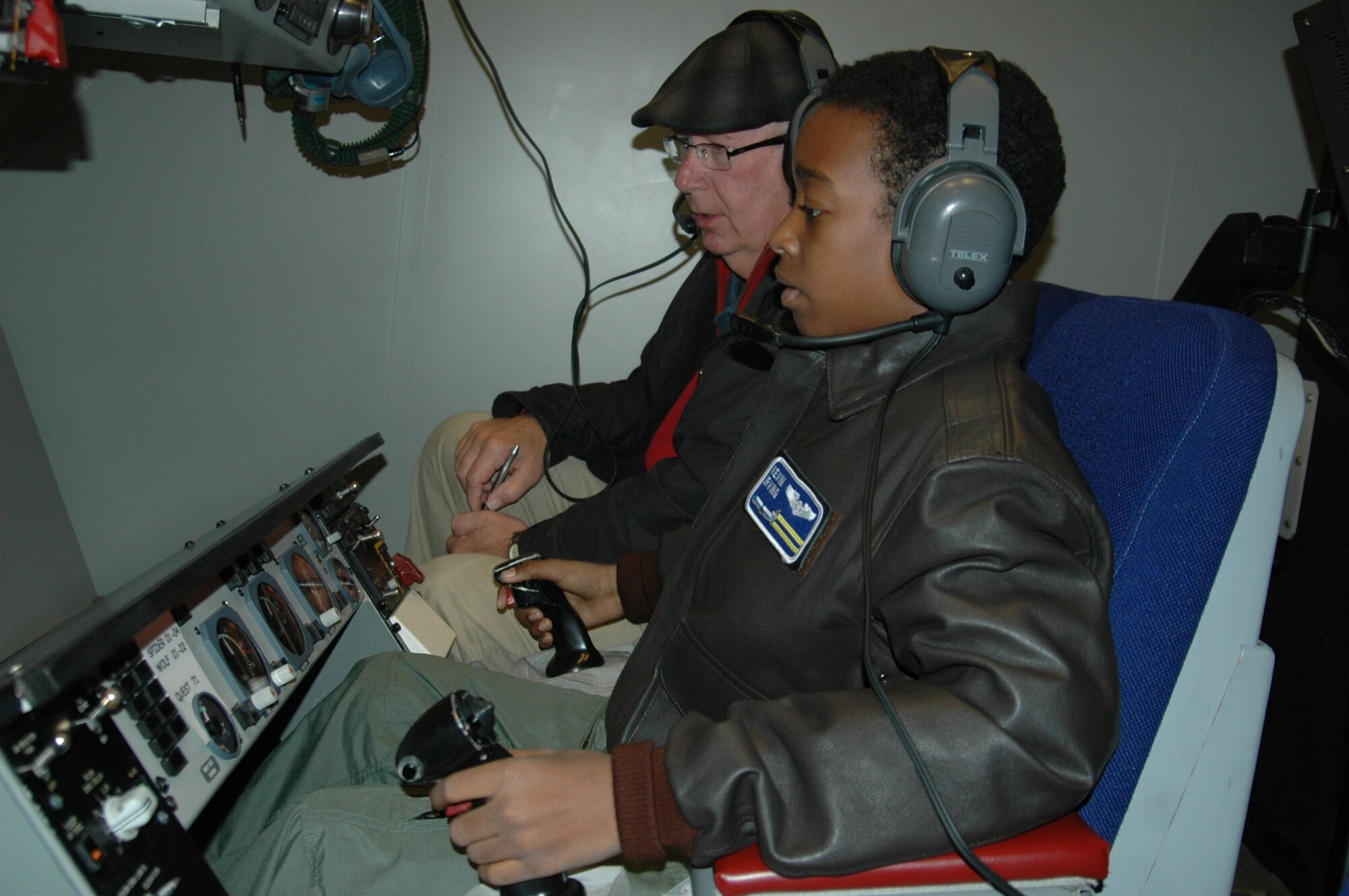 Kevin Irving, 14, learns to fly in the KC-10 Extender simulator Dec. 16 at Travis Air Force Base. (U.S. Air Force photo/Tyler Grimes)