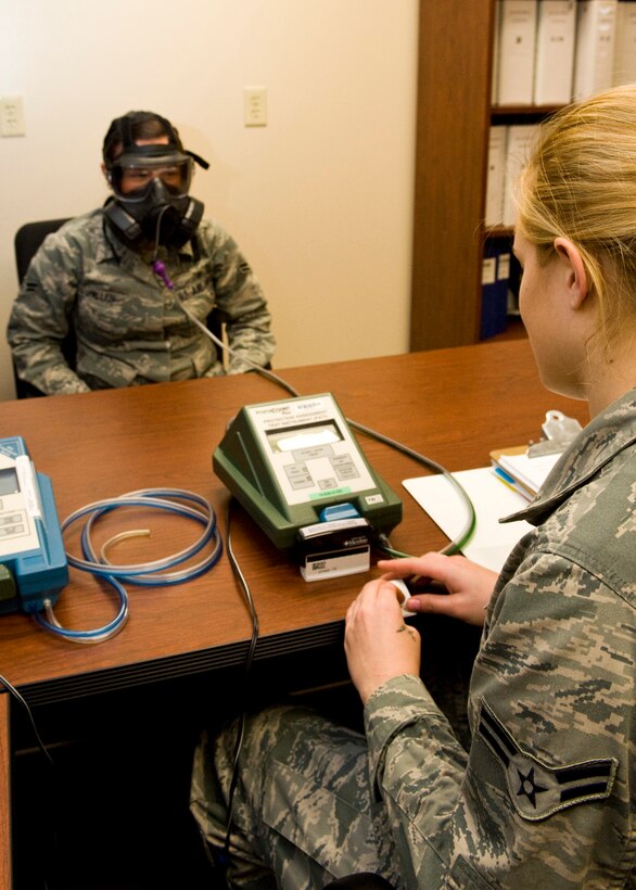 Airman 1st Class Spencer Hearn, 28th Medical Operations Squadron bioenvironmental engineer technician, performs a gas mask fit test on Airman 1st Class Lauren Allen, 28th Medical Operations Squadron bioenvironmental engineer technician, on Ellsworth Air Force Base, S.D., Nov. 30, 2011. Hearn used a portacount plus fit tester to ensure the M50 gas mask had a proper seal. (U.S. Air Force photo by Airman Alystria Maurer/Released)