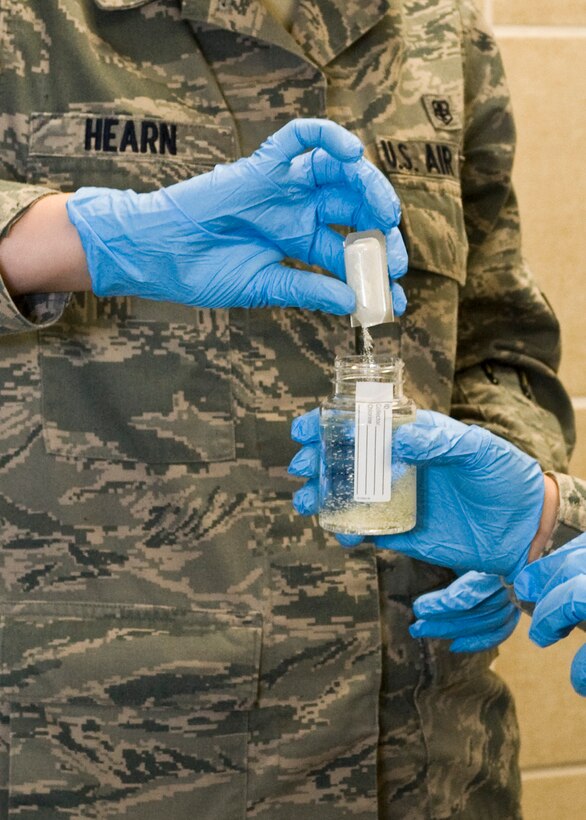 Airman 1st Class Spencer Hearn, 28th Medical Operations Squadron bioenvironmental engineer technician, uses Colilert testing agent to test water on Ellsworth Air Force Base, S.D., Nov. 30, 2011. Hearn tested water in the base swimming pool to determine if any E.coli bacteria or coliforms were present, after thorough testing the results came back negative for these bacteria. (U.S. Air Force photo by Airman Alystria Maurer/Released)