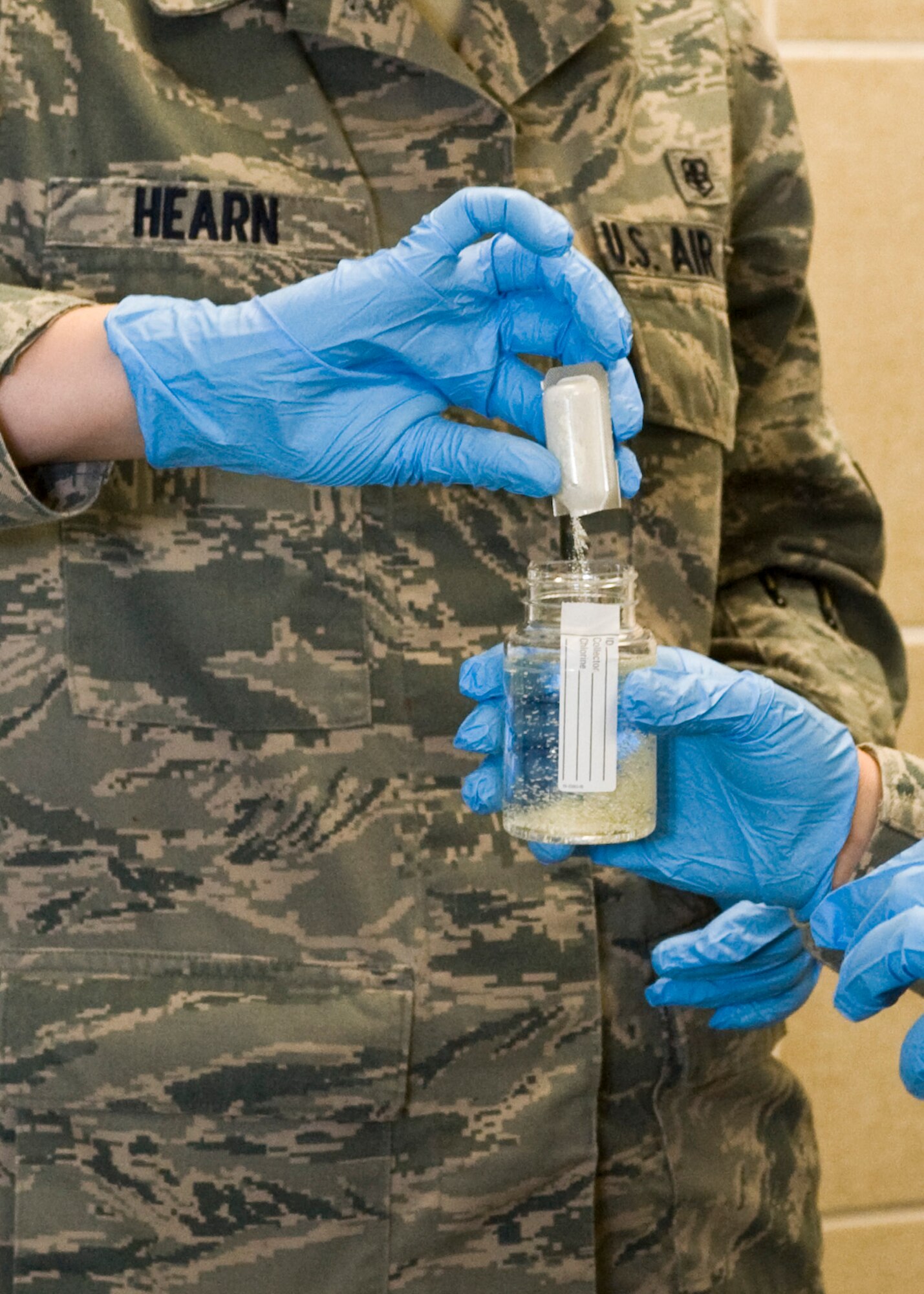Airman 1st Class Spencer Hearn, 28th Medical Operations Squadron bioenvironmental engineer technician, uses Colilert testing agent to test water on Ellsworth Air Force Base, S.D., Nov. 30, 2011. Hearn tested water in the base swimming pool to determine if any E.coli bacteria or coliforms were present, after thorough testing the results came back negative for these bacteria. (U.S. Air Force photo by Airman Alystria Maurer/Released)