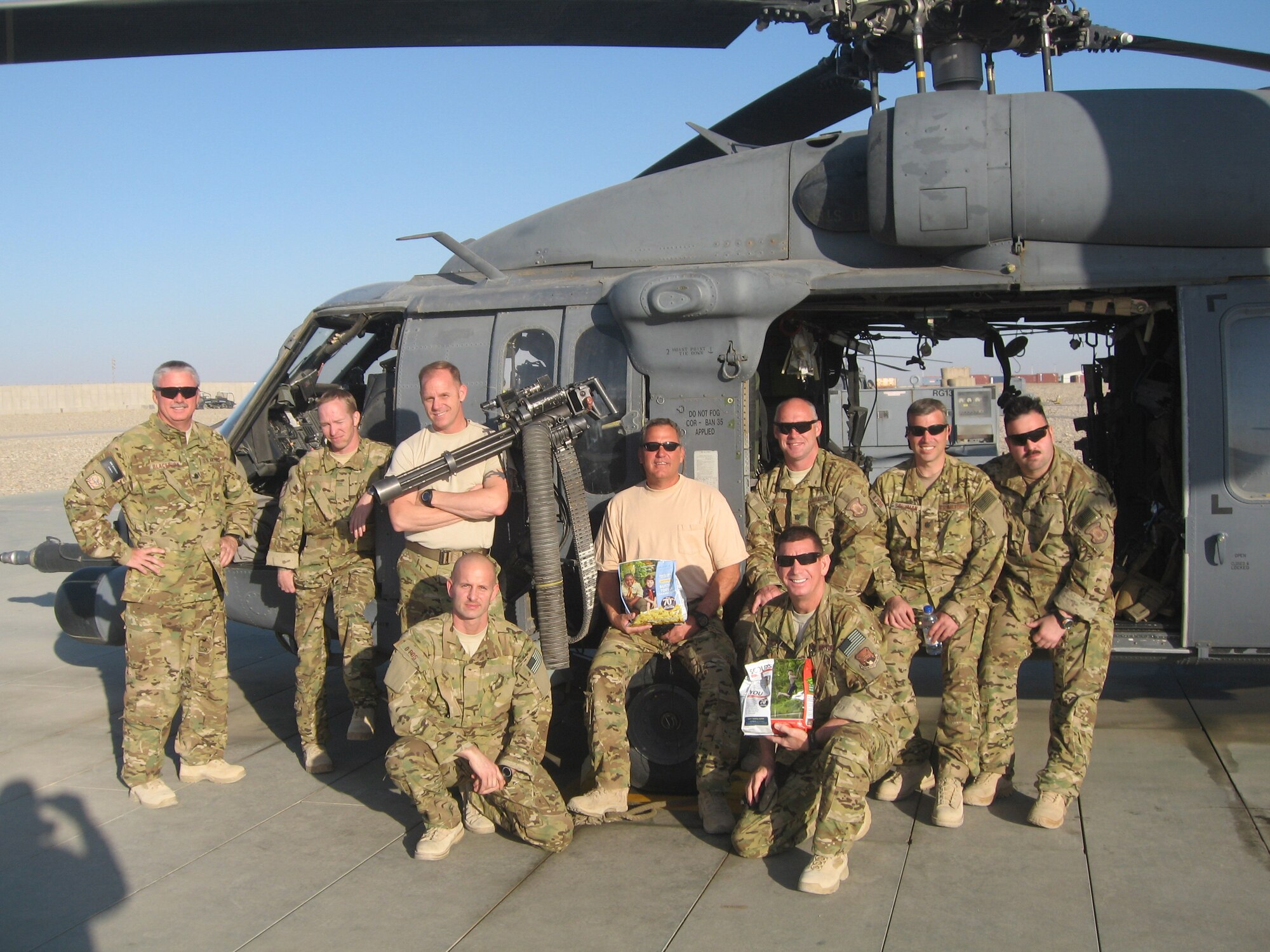 Reserve Rescue Airmen from the 920th Rescue Wing, Patrick Air Force Base, Fla., pose next to their HH-60G Pave Hawk helicopter in Afghanistan with bags of popcorn they received from local Space Coast boy scouts. Boy scouts from Troop 300 in Melbourne, Fla. presented 10 cases of assorted popcorn, from caramel to microwave kettle corn, to Lt. Col. Tony Cunha, 920th RQW Operations Support Squadron Commander and the troop's assistant troop master, on behalf of the 920th RQW Commander, Col. Jeffrey Commander, at one of their weekly meetings last fall. (Courtesy photo)