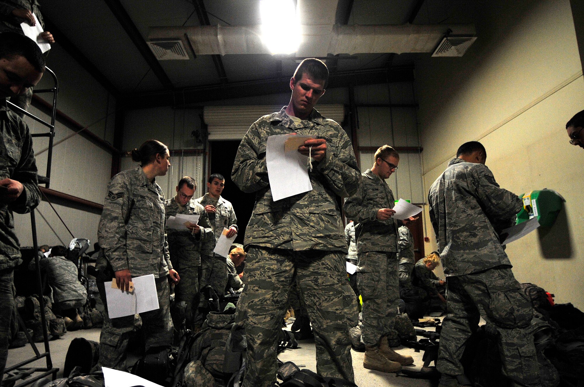 Staff Sgt. Michael Braach prepares to turn in his weapon Dec. 18, 2011, at an undisclosed location in Southwest Asia. Braach and his fellow Airmen are the last service members to redeploy from Iraq based on the Iraq and U.S. 2008 Security Agreement that required all U.S. service members to be out of the country by Dec. 31. Braach is a firefighter assigned to the 407th Air Expeditionary Group. (U.S. Air Force photo/Master Sgt. Cecilio Ricardo)