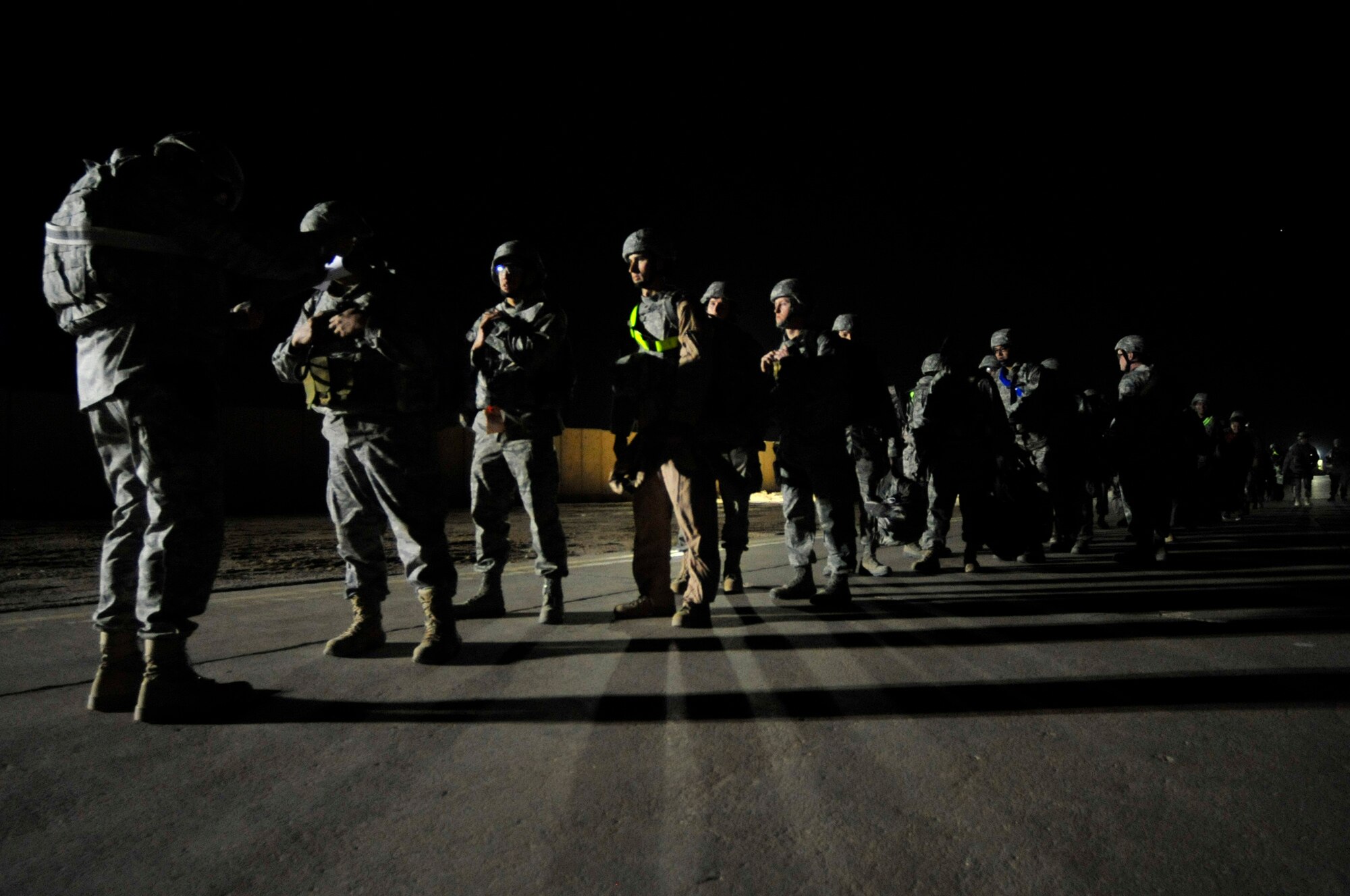 Airmen assigned to the 407th Air Expeditionary Group prepare to board a C-17 Globemaster III Dec. 18, 2011, at Ali Air Base, Iraq. The Airmen are the last service members to leave Iraq. Since 2003, more than one million service members have served in Iraq. (U.S. Air Force photo/Master Sgt. Cecilio Ricardo)