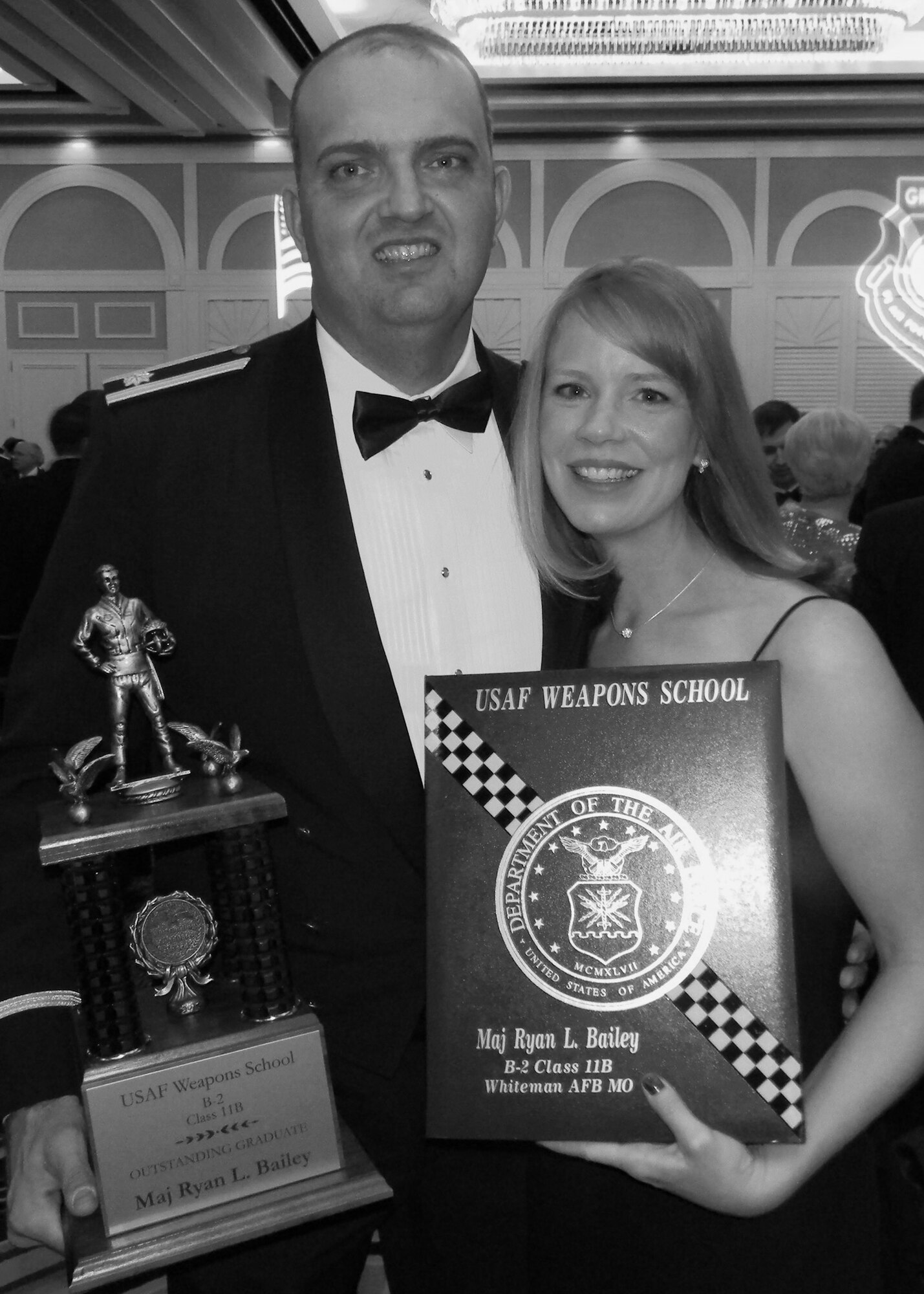 B-2 bomber pilot Maj Ryan "Poacher" Bailey, 131st Bomb Wing, Missouri Air National Guard, with his wife, Angie Bailey, shows his U.S. Air Force Weapons School graduation plaque and the Outstanding graduate for Class 11-B Trophy. Bailey was one of 90 graduating officers at the ceremony held at the Flamingo Hotel and Casino, Dec 10.  (Air National Guard Courtesy Photo)