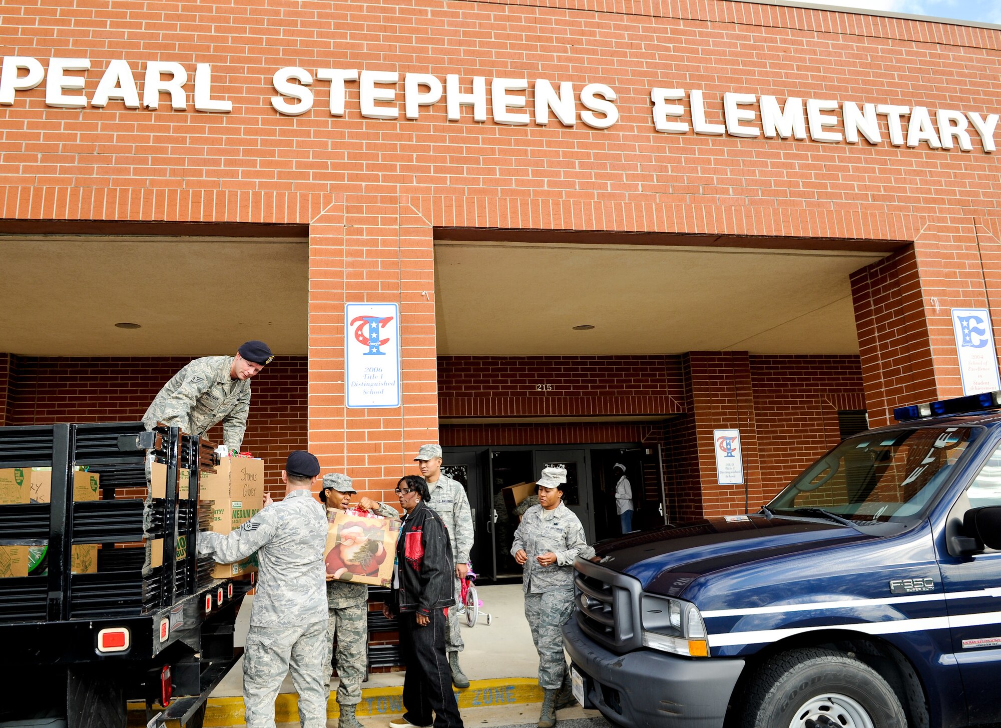 U.S. Air Force Airman from the 116th and 461st Air Control Wings (ACW), Robins Air Force Base, Ga., unload food and toys at Pearl Stephens Elementary school, Warner Robins, Ga., Dec. 9, 2011.  The items were donated through the annual Family-2-Family project coordinated by the 116th and 461st ACW.  The project provides food and toys to community and military families for the holidays.  
(National Guard photo by Master Sgt. Roger Parsons/Released)

