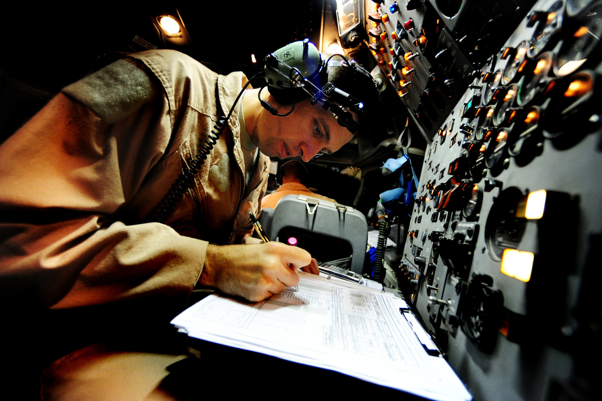U.S. Air Force Tech Sgt. Jerry Pierson a Joint Surveillance Target Attack Radar System (JSTARS) flight engineer from the 7th Expeditionary Air Combat Command Squadron, conducts in-flight operations as he and his fellow aircrew escorts the last ground convoy out of Iraq 18 Dec, 2011. during the last combat  mission over Iraqi air space. The JSTARS provided airborne, stand-off range, surveillance and target acquisition radar and command and control capabilities to ground personnel. Pierson is from Sturgis, Ky (U.S. Air Force photo/ Tech. Sgt. DeNoris A. Mickle)