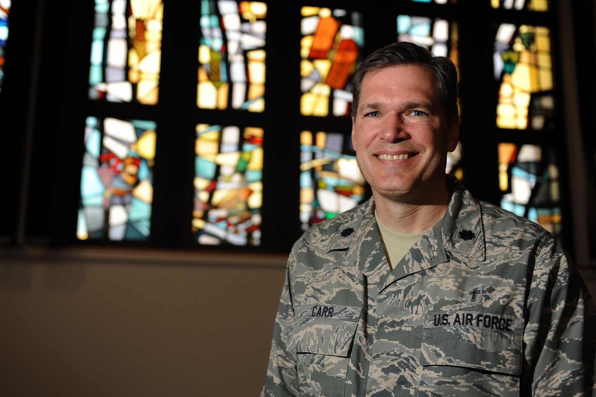 SPANGDAHLEM AIR BASE, Germany -- Chaplain (Lt. Col.) David Carr, 52nd Fighter Wing chaplain, poses for a photo inside the base chapel here Dec. 14. Carr is one of five chaplains available to all Airmen here providing spiritual care for Airmen and their families so they can exercise their religion freely. The chapel provides programs to nurture spiritual fitness to include services, studies and gatherings. (U.S. Air Force photo/ Airman 1st Class Matthew B. Fredericks)