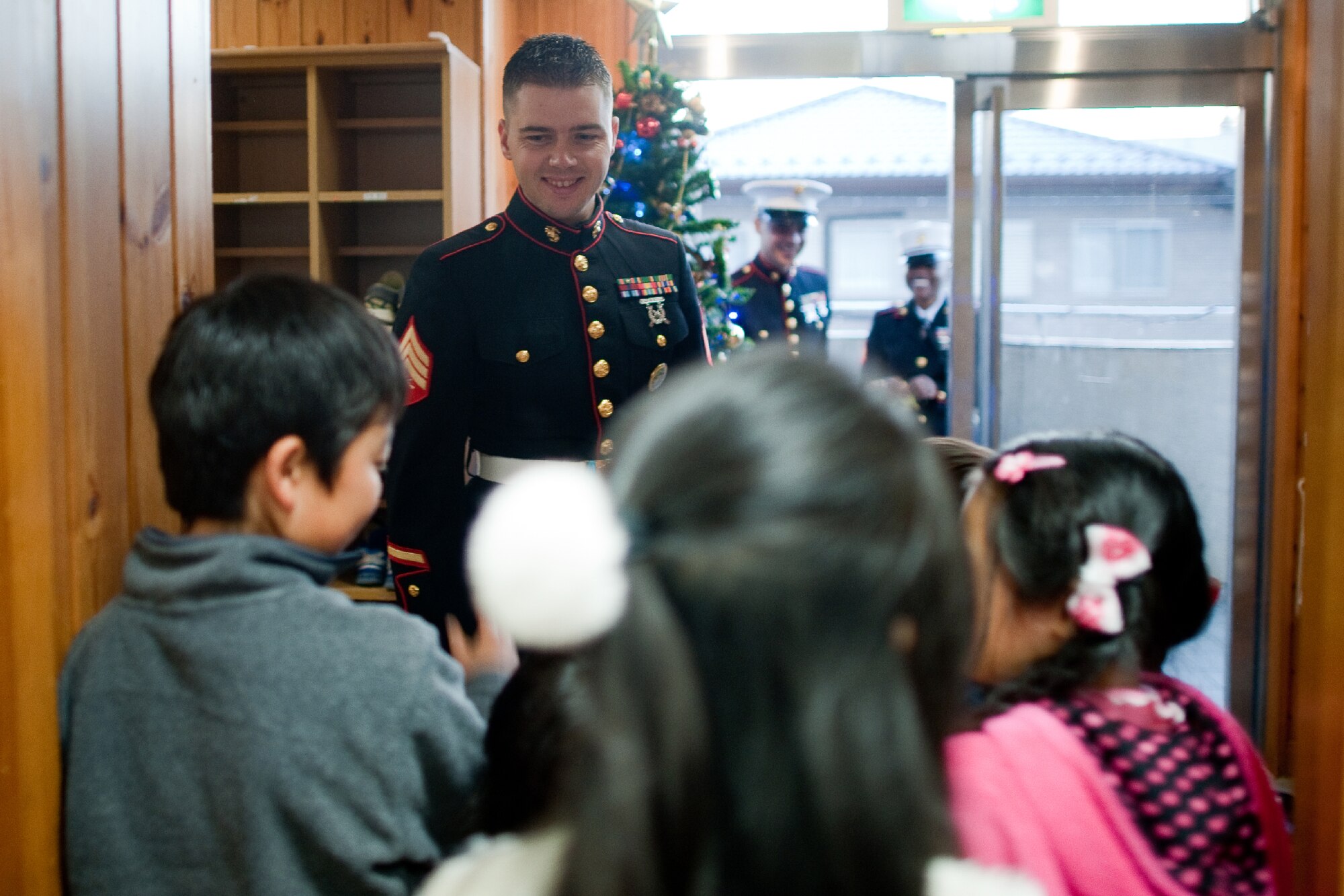 AKIRUNO CITY, Japan -- Children greet Sgt. Timothy Johnston, U.S. Forces Japan, at Ajiro Orphanage, Akiruno City, Tokyo, Japan, Dec. 16, 2011. Toys for Tots is a U.S. Marine Corps Reserve program that is designed for the collection of new, unwrapped toys during October, November and December each year, for distribution of those toys as gifts to needy children in the community during the holiday season. Marines at Yokota AB distributed the toys collected to children at local orphanages.  (U.S. Air Force photo/Osakabe Yasuo) 