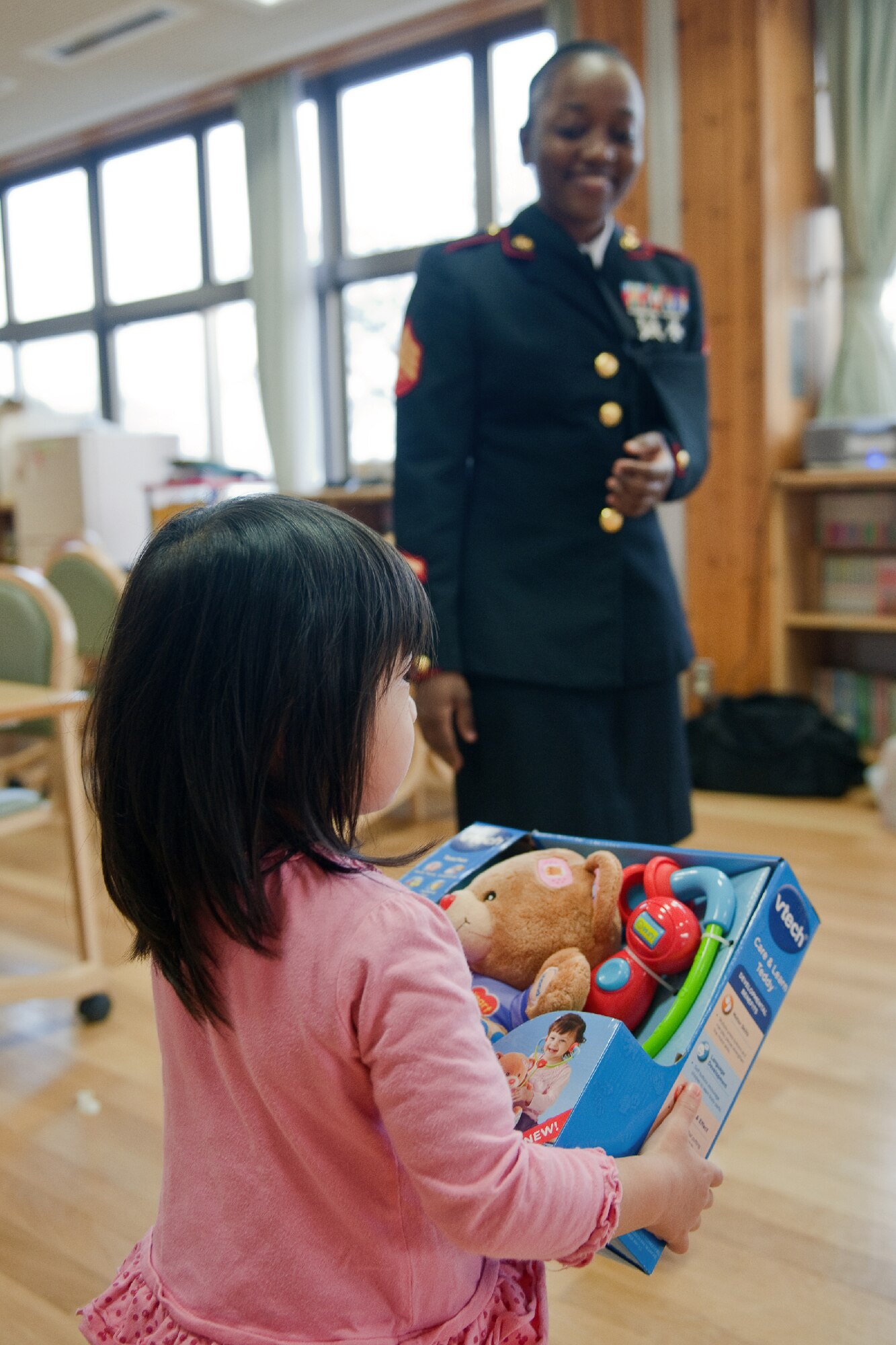 AKIRUNO CITY, Japan -- A child receives a toy as a Christmas gift from Sgt. Stacian Manglay, U.S. Forces Japan, at Ajiro Orphanage, Akiruno City, Tokyo, Japan, Dec. 16, 2011. Toys for Tots is a U.S. Marine Corps Reserve program that is designed for the collection of new, unwrapped toys during October, November and December each year, for distribution of those toys as gifts to needy children in the community during the holiday season. Marines at Yokota AB distributed the toys collected to children at local orphanages. (U.S. Air Force photo/Osakabe Yasuo)    