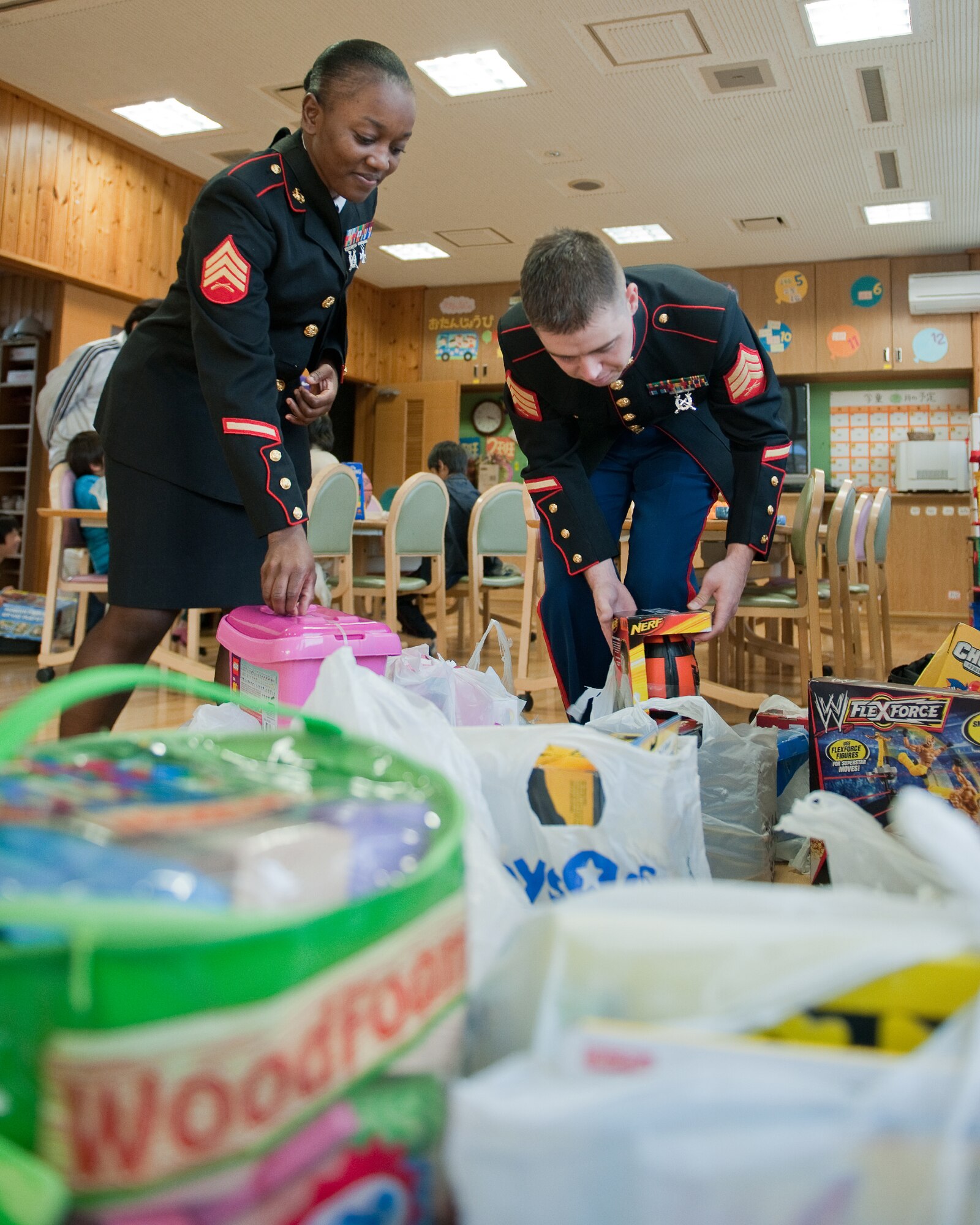 AKIRUNO CITY, Japan -- (left to right) Sgt. Stacian Manglay and Sgt. Timothy Johnston, both from U.S.  Forces Japan, prepare to present toys as Christmas gift to the children of the Ajiro Orphanage, Akiruno City, Tokyo, Japan, Dec. 16, 2011. Toys for Tots is a U.S. Marine Corps Reserve program that is designed for the collection of new, unwrapped toys during October, November and December each year, for distribution of those toys as gifts to needy children in the community during the holiday season. Marines at Yokota AB distributed the toys collected to children at local orphanages. (U.S. Air Force photo/Osakabe Yasuo)