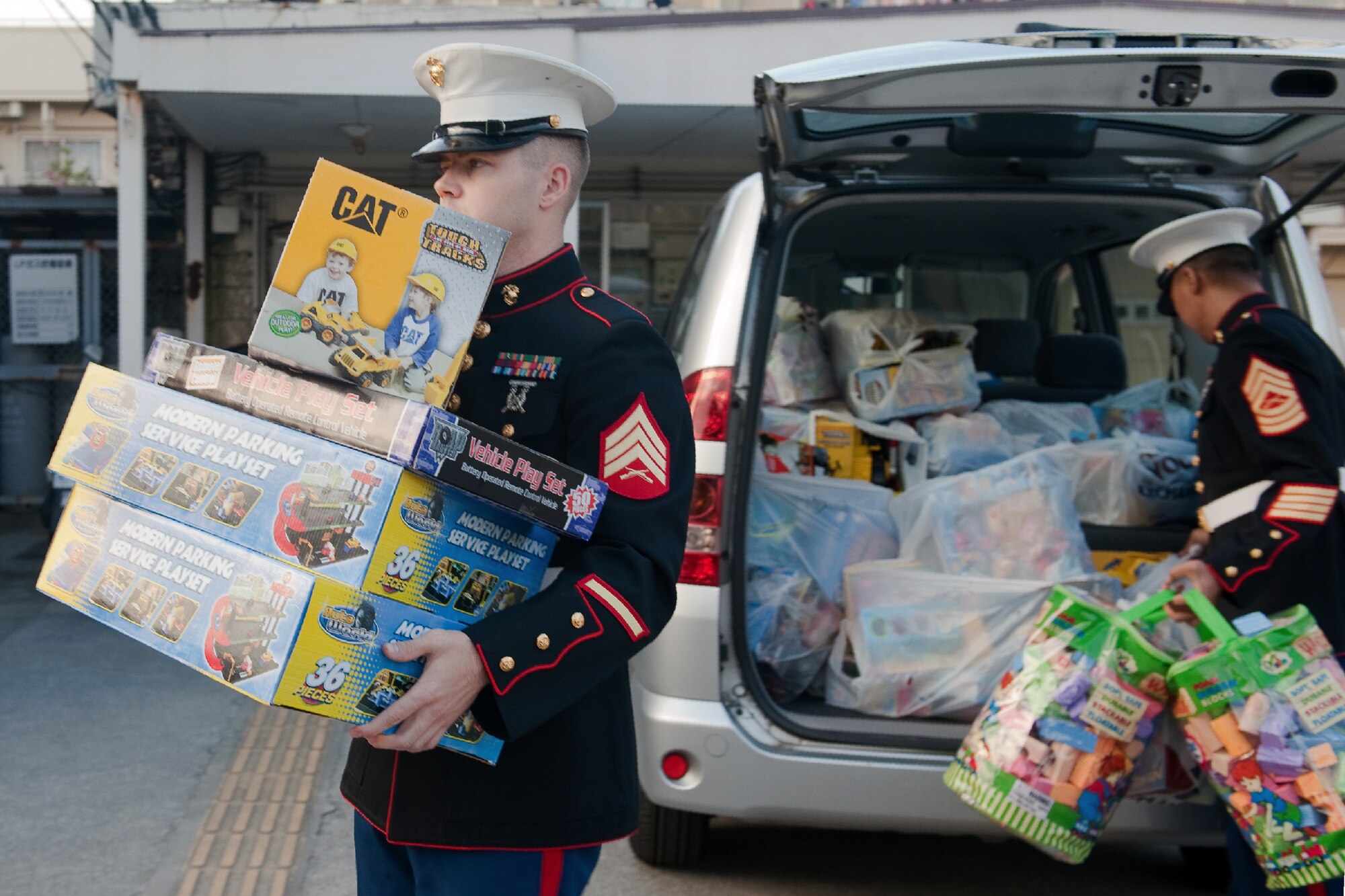 AKIRUNO CITY, Japan -- Sgt. Timothy Johnston, U.S. Forces Japan, unloads toys for Christmas gifts at Ajiro Orphanage, Akiruno City, Tokyo, Japan, Dec. 16, 2011. Toys for Tots is a U.S. Marine Corps Reserve program that is designed for the collection of new, unwrapped toys during October, November and December each year, for distribution of those toys as gifts to needy children in the community during the holiday season. Marines at Yokota AB distributed the toys collected to children at local orphanages. (U.S. Air Force photo/Osakabe Yasuo)  