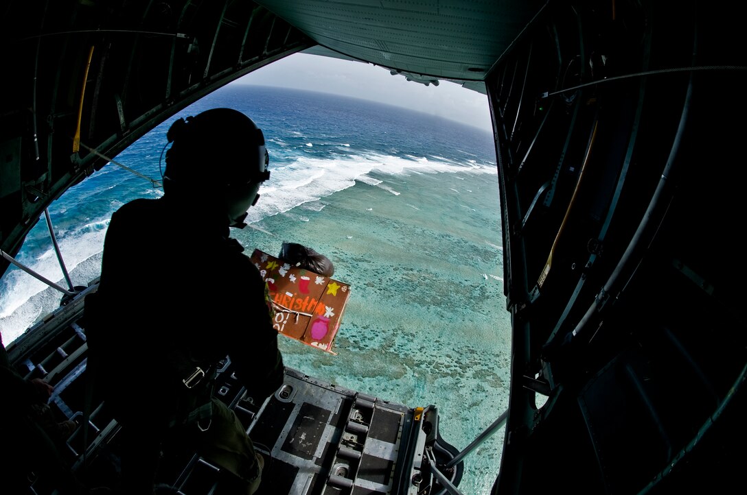 Staff Sgt. Kyle Favorite, 374th Airlift Wing loadmaster, from Yokota Air Base Japan , pushes a pallet out of a C-130 Hercules over the island of Fais, Dec. 15. Operation Christmas Drop 2011 is an annual event, airlifting pallets for 57 islands of Micronesia. The pallets contain school supplies, toys, medical supplies, and common day items. (U.S. Air Force photo/Staff Sgt. Alexandre Montes)