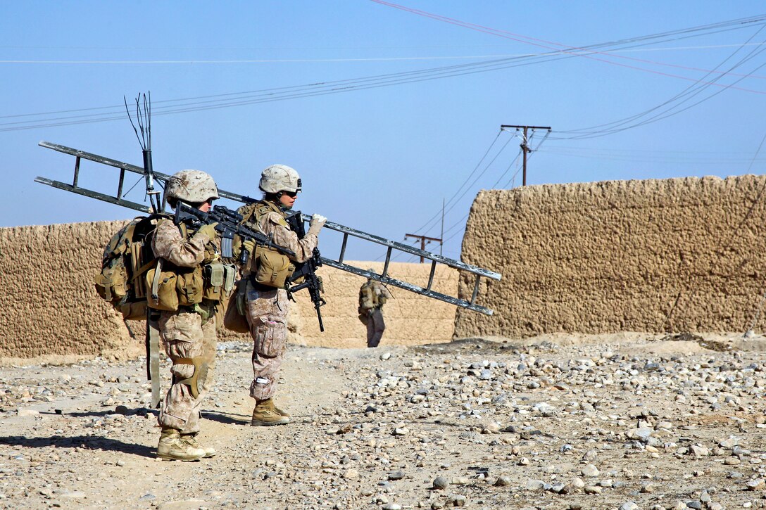 U.S. Marine Corps Sgts. Autumn Sekely, right, and Jessica Lugo, left, provide support for a patrol in the Sangin district of Afghanistan's Helmand province, Dec. 7, 2011. Sekely and Lugo are assigned to 2nd Marine Division, Female Engagement Team 6, and provide support to Weapons Company, 3rd Battalion, 7th Marine Regiment.