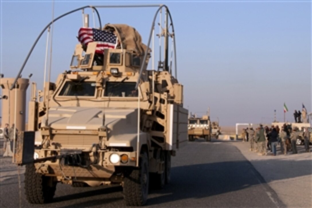 A U.S. flag flies from a Mine Resistant Ambush Protected vehicle, part of the last convoy to leave Iraq, as it crosses over into Kuwait, Dec. 18, 2011, signaling the end of Operation New Dawn. Despite the final battalions' departure, the U.S. will continue to build and strengthen a mutually-beneficial partnership with Iraq. 