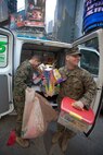 NEW YORK -- Marines from 6th Communication Battalion, a Marine Forces Reserve unit based in Floyd Bennett Field, Brooklyn, collect toys in Times Square as part of their Toys for Tots drive, Dec. 19. The Marines will be in Times Square all week loading up their tactical vehicles with toys collected from all of their New York City drop off locations as part of their final collection effort. Last year the Marines from 6th Communication Battalion collected approximately 280,000 toys, the majority of them being collected during this last-week scramble before Christmas. (Official Marine Corps photo by Cpl. Caleb Gomez / RELEASED)