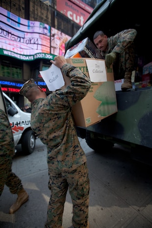 NEW YORK -- Marines from 6th Communication Battalion, a Marine Forces Reserve unit based in Floyd Bennett Field, Brooklyn, collect toys in Times Square as part of their Toys for Tots drive, Dec. 19. The Marines will be in Times Square all week loading up their tactical vehicles with toys collected from all of their New York City drop off locations as part of their final collection effort. Last year the Marines from 6th Communication Battalion collected approximately 280,000 toys, the majority of them being collected during this last-week scramble before Christmas. (Official Marine Corps photo by Cpl. Caleb Gomez / RELEASED)