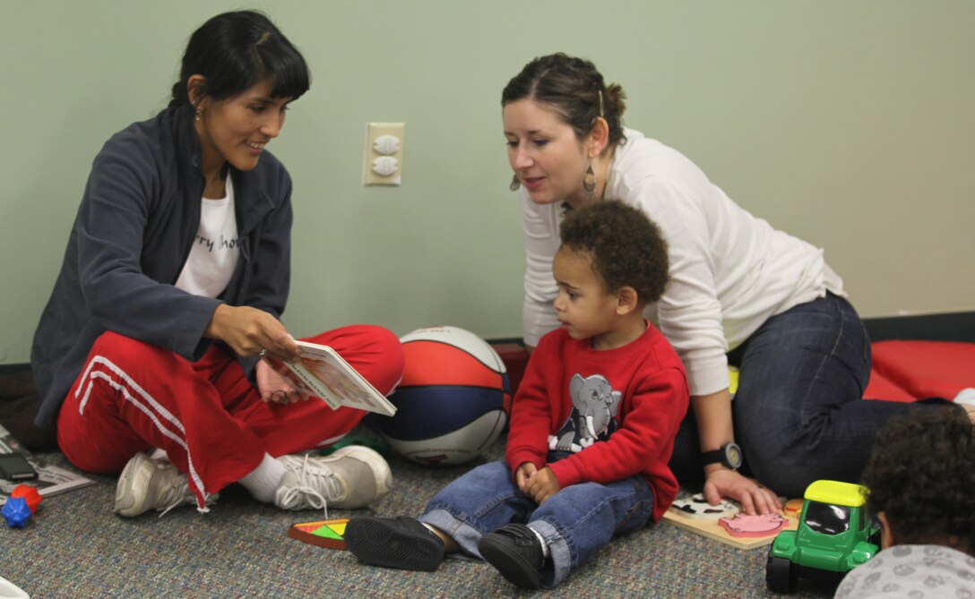 A mother reads to a child at Midway Park Community Center's Community Playdate Dec. 20. The event is held weekly at the Midway Park Community Center on Tuesdays.