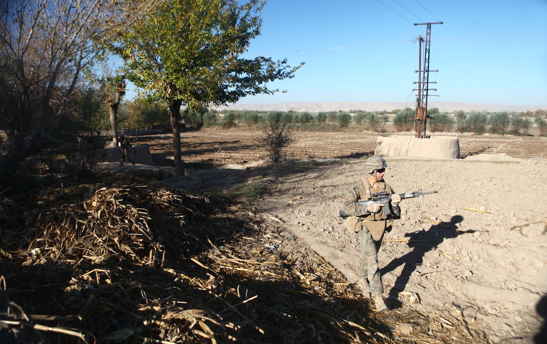 A Marine with Company A, 1st Battalion, 6th Marine Regiment, patrols here, Nov. 30. The Marines take part in counterinsurgency operations in the Sangin District, limiting support for an insurgency with longstanding ties to local communities.