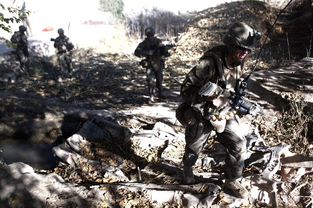 A Marine with Company A, 1st Battalion, 6th Marine Regiment, patrols here, Nov. 30. The Marines take part in counterinsurgency operations in the Sangin District, limiting support for an insurgency with longstanding ties to local communities.