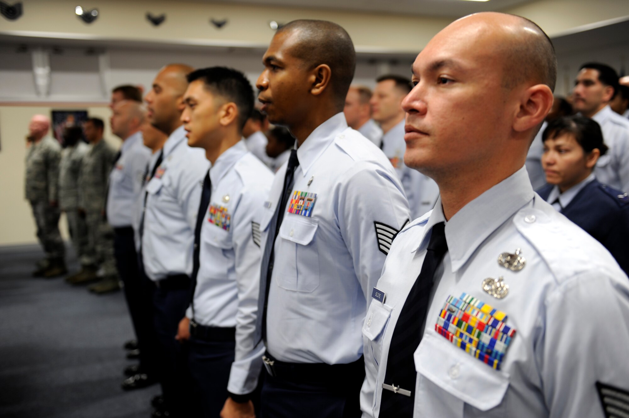 Members of NCO Academy Class 12-1 prepare to recite the Airman's Creed during the rededication of the Erwin Professional Military Education Center on Kadena Air Base, Japan, Dec. 16, 2011. The more than two-year construction project yielded an array of upgrades including a new library and improvements to offices and classrooms to facilitate the further instilment of professional development for NCOs who pass through the halls. (U.S. Air Force photo by Airman 1st Class Maeson L. Elleman/Released)