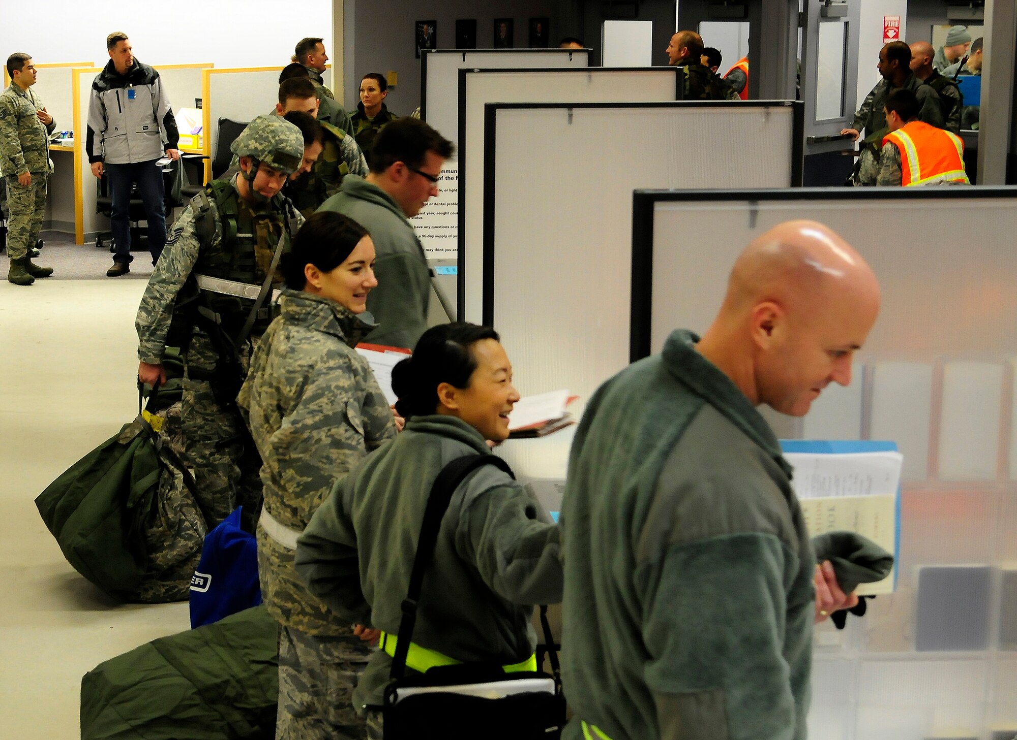 U.S. Airmen process through a pre-deployment line during an Operational Readiness Exercise at the Joint Mobility Complex, Dec. 14, 2011, Eielson Air Force Base, Alaska. During the processing line, Airmen have their records reviewed and ensure personal issues are taken care of prior to deploying. (U.S. Air Force photo by Airman 1st Class Yash Rojas/Released)
