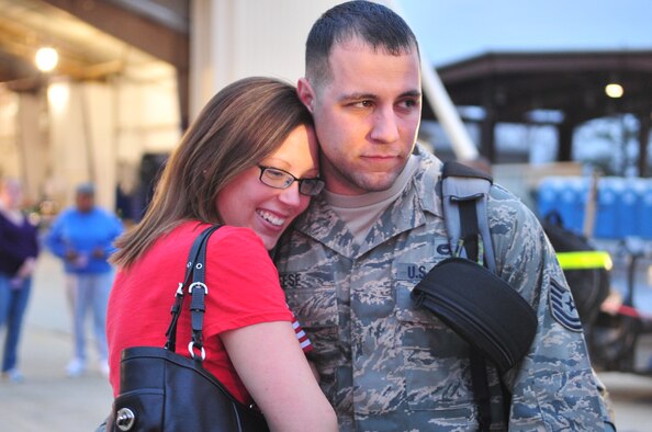Brandy Reese hugs her husband, Tech Sgt. Carmine Reese, as he returned home from a deployment to Bagram Airfield, Afghanistan, on Seymour Johnson Air Force Base, N.C., Dec. 20, 2011. During his deployment, Reese was part of the 455th Air Expeditionary Wing, which provides close air support to more than 20,000 servicemembers in Afghanistan. Reese is an avionics technician with the 4th Aircraft Maintenance Squadron and hails from Brooklyn, N.Y. (U.S. Air Force photo by Senior Airman Marissa Tucker) 