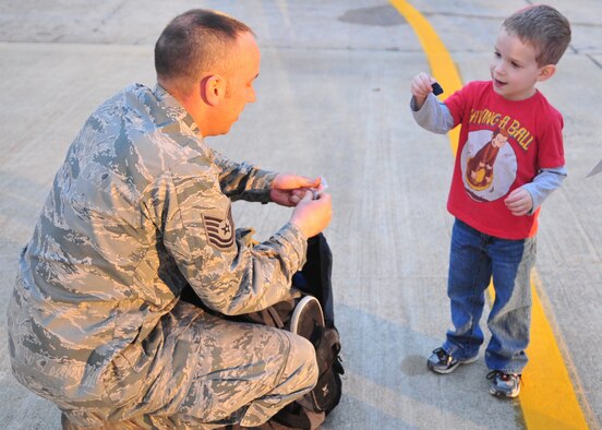 Nathan Kennedy, 4, admires dog tags from his father, Tech Sgt. James Kennedy during a homecoming ceremony on Seymour Johnson Air Force Base, N.C., Dec. 20, 2011. More than 100 Seymour Johnson Airmen returned from a deployment to Bagram Airfield, Afghanistan just in time for the holiday season. Kennedy, a 4th Aircraft Maintenance Squadron technical and acquisition management section chief, hails from Monroe, La. (U.S. Air Force photo by Senior Airman Marissa Tucker)
