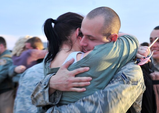 Airman 1st Class Brett Thein hugs his wife, Hillary during a homecoming celebration at Seymour Johnson Air Force Base, N.C., Dec. 20, 2011. Thein, a 4th Aircraft Maintenance Squadron technical and acquisition management specialist, returned from his first deployment and plans to celebrate the holidays with his wife and family. Thein hails from Waukesha, Wisc. (U.S. Air Force photo by Senior Airman Marissa Tucker)