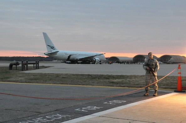 Staff Sgt. Brett Merrell, 4th Security Forces Squadron patrolman, provides security on the flightline at Seymour Johnson Air Force Base, N.C., Dec. 20, 2011. Families came together to welcome Airmen from various career fields that will return home from Bagram Airfield, Afghanistan, over the next few days. (U.S. Air Force photo by Airman 1st Class Mariah Tolbert) 