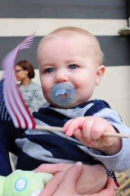 Cannon Higgins, 7 months old, waves an American flag while waiting for his father, Capt. Josh Higgins, 335th Fighter Squadron F-15E Strike Eagle pilot, to return to Seymour Johnson Air Force Base, N.C., Dec. 20, 2011. Higgins was on a deployment to Bagram Airfield, Afghanistan, and will return in time to celebrate the holidays with his family. He is a native of Carthage, Texas. (U.S. Air Force photo by Senior Airman Rae Perry)