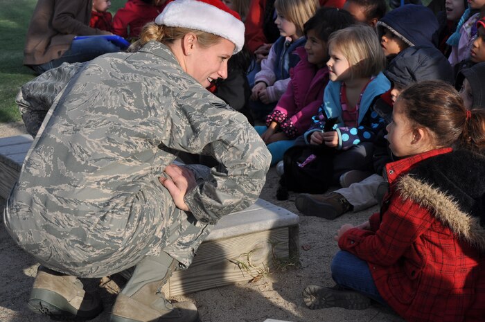 Senior Airman Megan Hokaj greets a young fan after a holiday show at the Child Development Center at Beale Air Force Base Calif., Dec. 14 2011. Hokaj is a member of the band Mobility based at Travis AFB. (U.S. Air Force photo by Staff Sgt. Robert M. Trujillo/Released)