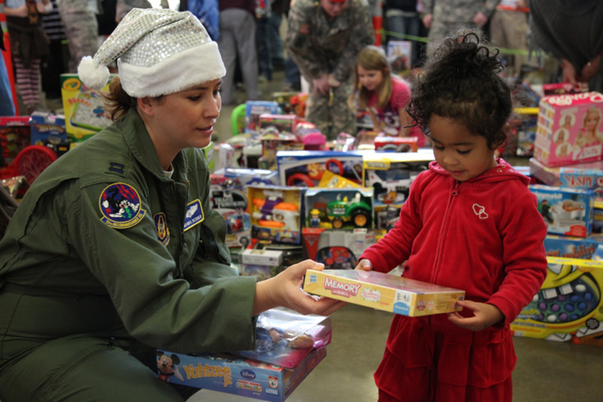 A 940th Wing Reservist from Beale Air Force Base, Calif., helps a military child select a toy at the Never Forget Our Fallen Organization's Military Children’s Christmas party, Dec. 17, 2011, at the California Army National Guard Readiness Center, in Roseville, Calif. The 4th annual event provided local military children with hundreds of’ new toys for the holiday. (U.S. Air Force photo/Tech. Sgt. Kenneth McCann)