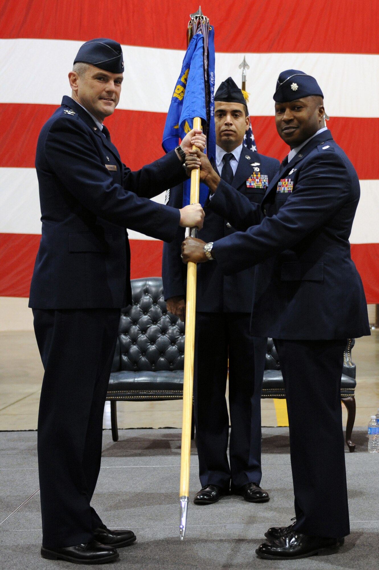 Lt. Col. Brian Watkins (right), the new 53rd Airlift Squadron commander, accepts the guidon from Col. Andrew McIntyre, 19th Operations Group commander, Dec. 20, 2011,during a change of command ceremony at Little Rock Air Force Base, Ark. The 53rd AS employs 160 active duty Airmen and 10 C-130 aircraft to provide worldwide combat airlift. Lt. Col. Ken Kopp, incoming 515th Air Mobility Operations Group deputy group commander, relinquished command of the 53rd AS. (U.S. Air Force photo by Airman 1st Class Rusty Frank)