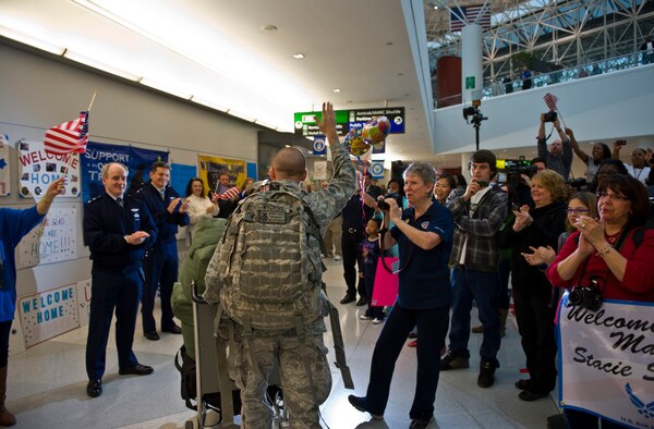 Senior Airman Nathan Wyckoff is greeted by Air Force leaders and community members as he enters the lobby Dec. 20, 2011, at Baltimore/Washington International Thurgood Marshall Airport in Baltimore, Md. Wyckoff was one of the last Airmen to return from Iraq in support of the completed Operation New Dawn. Wyckoff is a patrolman assigned to the 30th Security Forces Squadron at Vandenberg Air Force Base, Calif. (U.S. Air Force photo/Tech. Sgt. Bennie Davis)