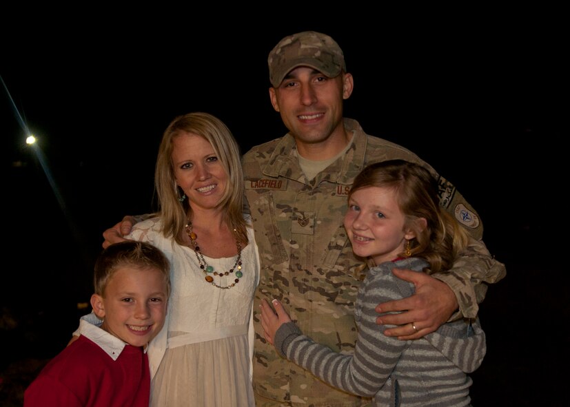 U.S. Air Force Staff Sgt. Jacob Lacefield, 823rd Base Defense Squadron, embraces his family after arriving home from a deployment in Kandahar Airfield, Afghanistan at Moody Air Force Base, Ga., Dec. 19, 2011. Lacefield and other members of the 820th Base Defense Group were called upon to utilize their specialized skills in support of Operation Enduring Freedom, but were lucky enough to arrive home just in time for the holidays. (U.S. Air Force photo by Senior Airman Eileen Meier/Released)