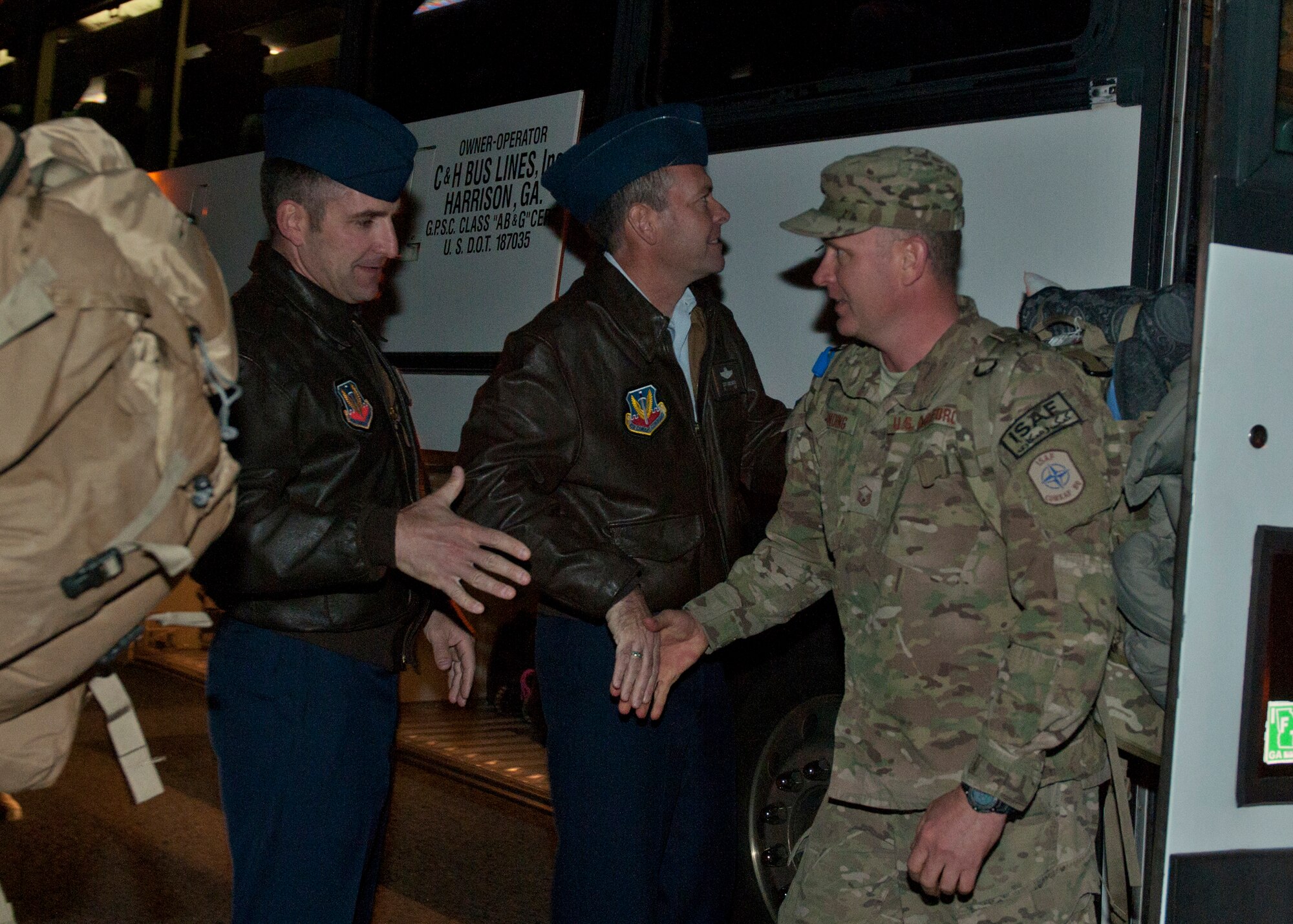 U.S. Air Force Chief Master Sgt. Atticus Smith, 93rd Air Ground Operations Wing command chief, and Col. Scott Kindsvater, 93rd AGOW commander, greet members of various units within the 820th Base Defense Group after a deployment in Kandahar Airfield, Afghanistan at Moody Air Force Base, Ga., Dec. 19, 2011. The 820th BDG is the only group at Moody AFB that can deploy in a moment’s notice, is a fully integrated unit, multidisciplined, highly qualified and has self-sustaining force protection capabilitilies. After three and a half months, the 820th BDG made it home just in time for the holidays. (U.S. Air Force photo by Senior Airman Eileen Meier/Released) 