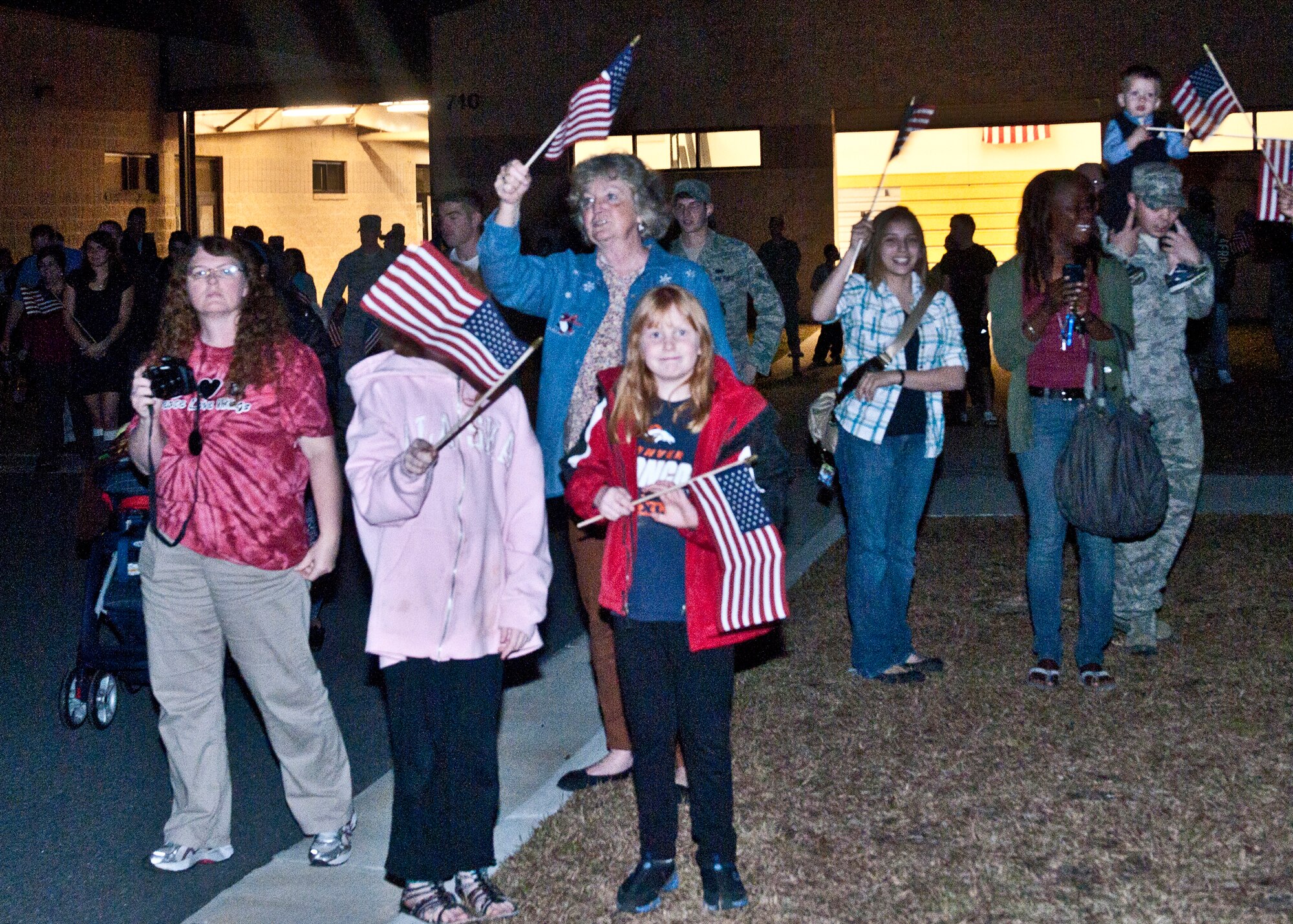 Family and friends gather around to welcome home Airmen from various units in the 820th Base Defense Group from their deployment in Kandahar Airfield, Afghanistan just in time for the holidays at Moody Air Force Base, Ga., Dec. 19, 2011. The Airmen of the 820th BDG were embraced with hugs, waving flags and handshakes from leadership as they got off the bus after their long journey home. (U.S. Air Force photo by Senior Airman Eileen Meier/Released) 
