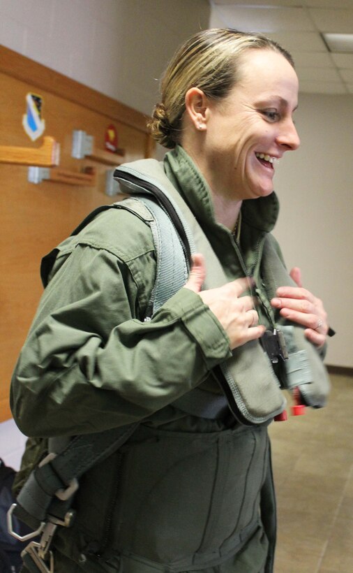 Master Sgt. Karrie Warren, assistant superintendent of the 601st Air and Space Operations Center’s Combat Operations Division, puts on flight gear at Tyndall Air Force Base, Fla., Dec. 15. Warren, who was the 601st AOC’s Senior Noncommissioned Officer of the Year, received an incentive flight in an F-4 as part of a new initiative designed to provide more rewards to the command’s top enlisted performers. (U.S. Air Force photo by Angela Pope)