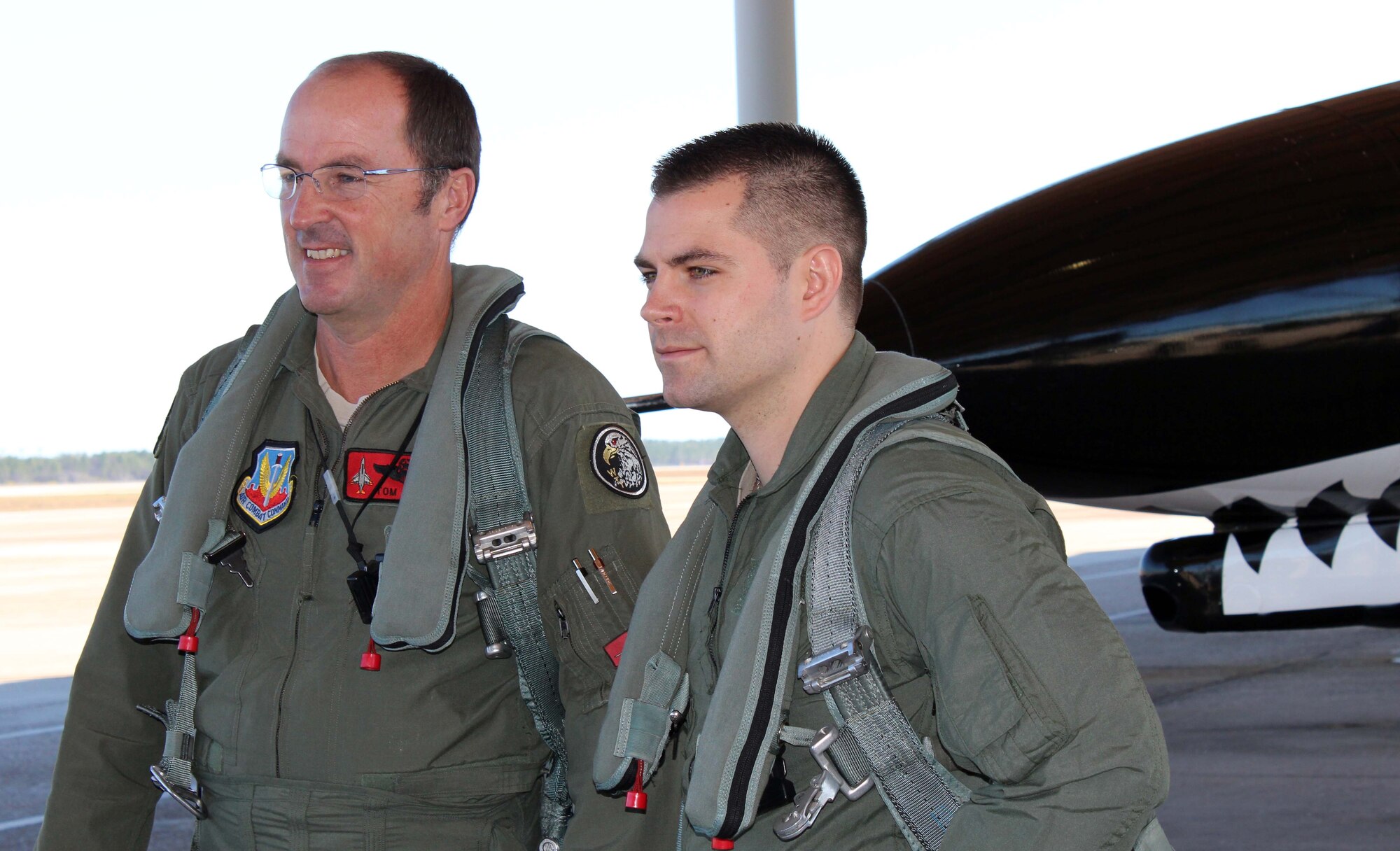 Staff Sgt. Brett Dunning (right), an intelligence analyst from the 601st Air and Space Operations Center, and Tom Mudge, an F-4 pilot from the 82nd Aerial Target Squadron, pause to take a picture before their flight at Tyndall Air Force Base, Fla., Dec. 14. Dunning, who was the 601st AOC’s Noncommissioned Officer of the Year, received an incentive flight in an F-4 as part of a new initiative designed to provide more rewards to the command’s top enlisted performers. (U.S. Air Force photo by Angela Pope) 