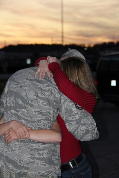 ROBINS AIR FORCE BASE, Ga. -- Tech. Sgt. Shawn Gambill, a 53rd Combat Communications Squadron cyber systems operations technician, embraces his wife Misty at a welcome home ceremony Dec. 19, 2011, at Robins Air Force Base, Ga. The returning communicators closed Sather Air Base operations and were some of the last Airmen to leave Iraq. (U.S. Air Force photo/Robert Talenti)

