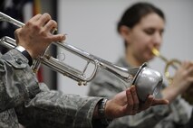 MINOT AIR FORCE BASE, N.D. – Staff Sgt. Patrick Brush, U.S. Air Force Heartland of America Band trumpet-horn player, uses a mute for his instrument during a performance at the 91st Missile Wing headquarters building here Dec. 16. The band toured Minot AFB for three days, performing at various locations, spreading good cheers and improving morale. (U.S. Air Force photo/Airman 1st Class Stephanie Ashley)